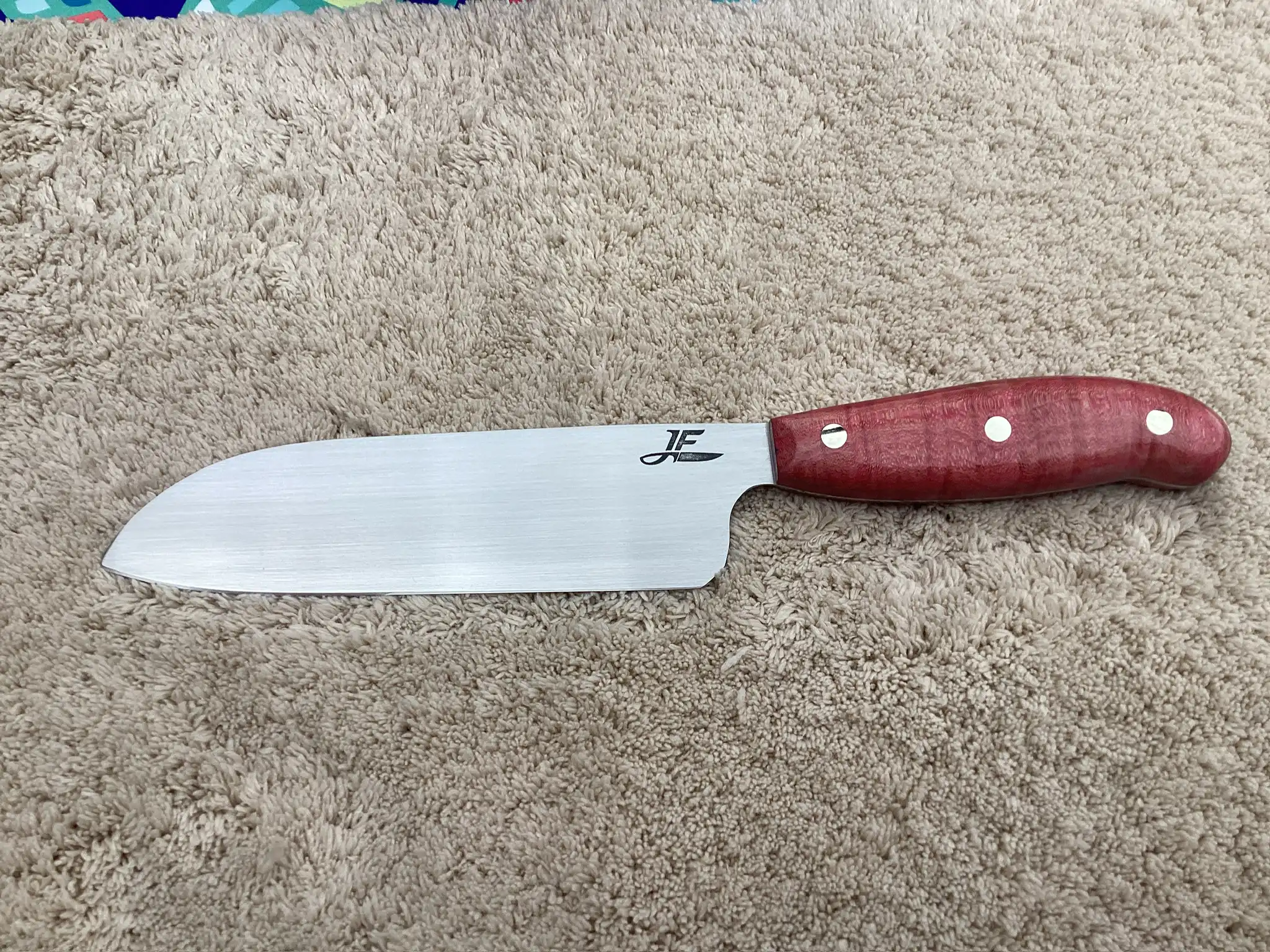 Chefs knife with pink/red stabilized wood handles - front view