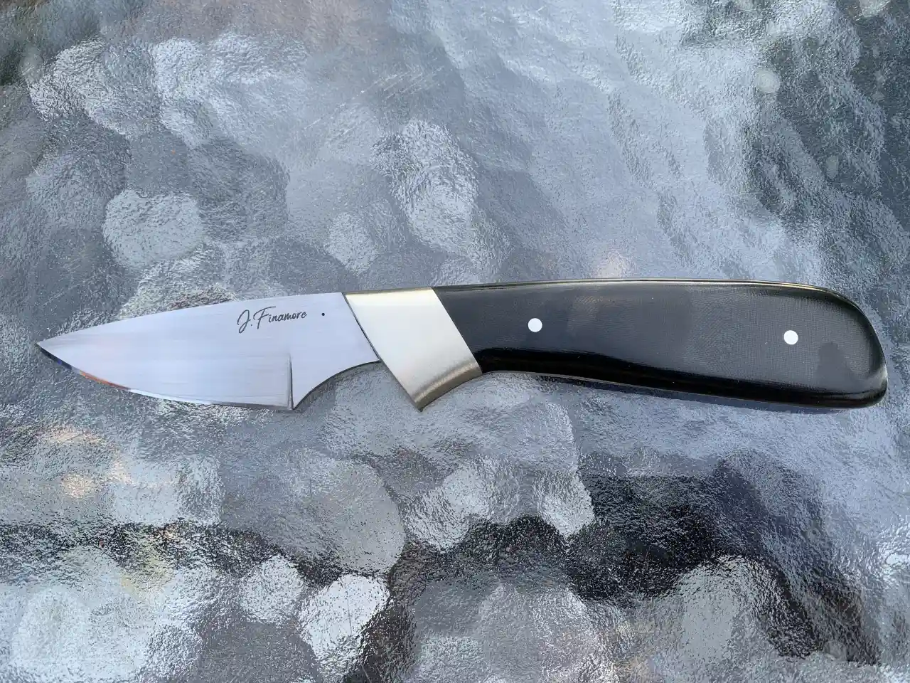 1084 carbon steel slim hunter with black micarta handles - front view