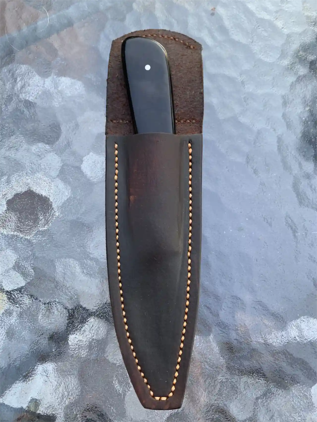 1084 carbon steel slim hunter with black micarta handles in leather sheath