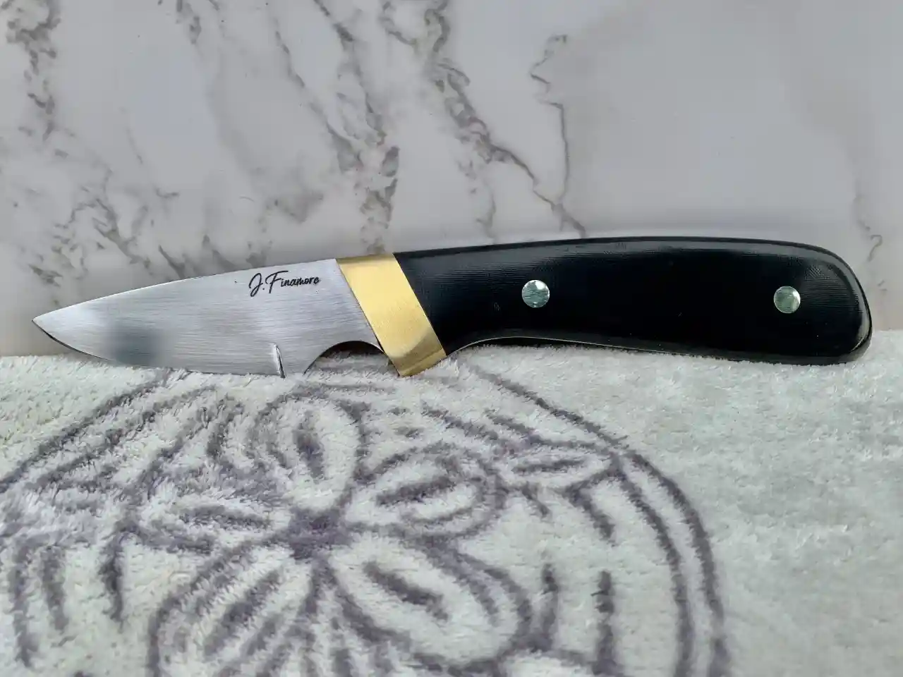 1084 carbon steel slim hunter with black canvas micarta handles - front view