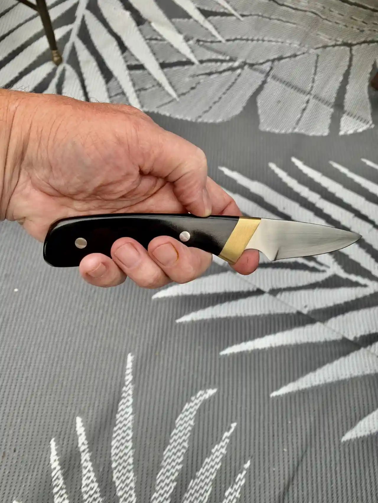 1084 carbon steel slim hunter with black canvas micarta handles - handheld