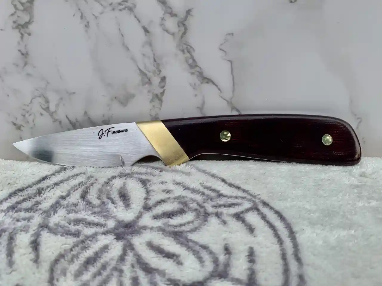 Stainess steel slim skinner with coral coored micarta  handles - front view