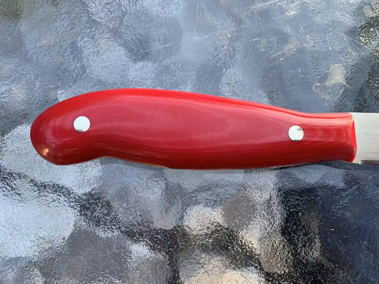 Kitchen paring knife with ruby red micarta handles - closeup of handle rear view
