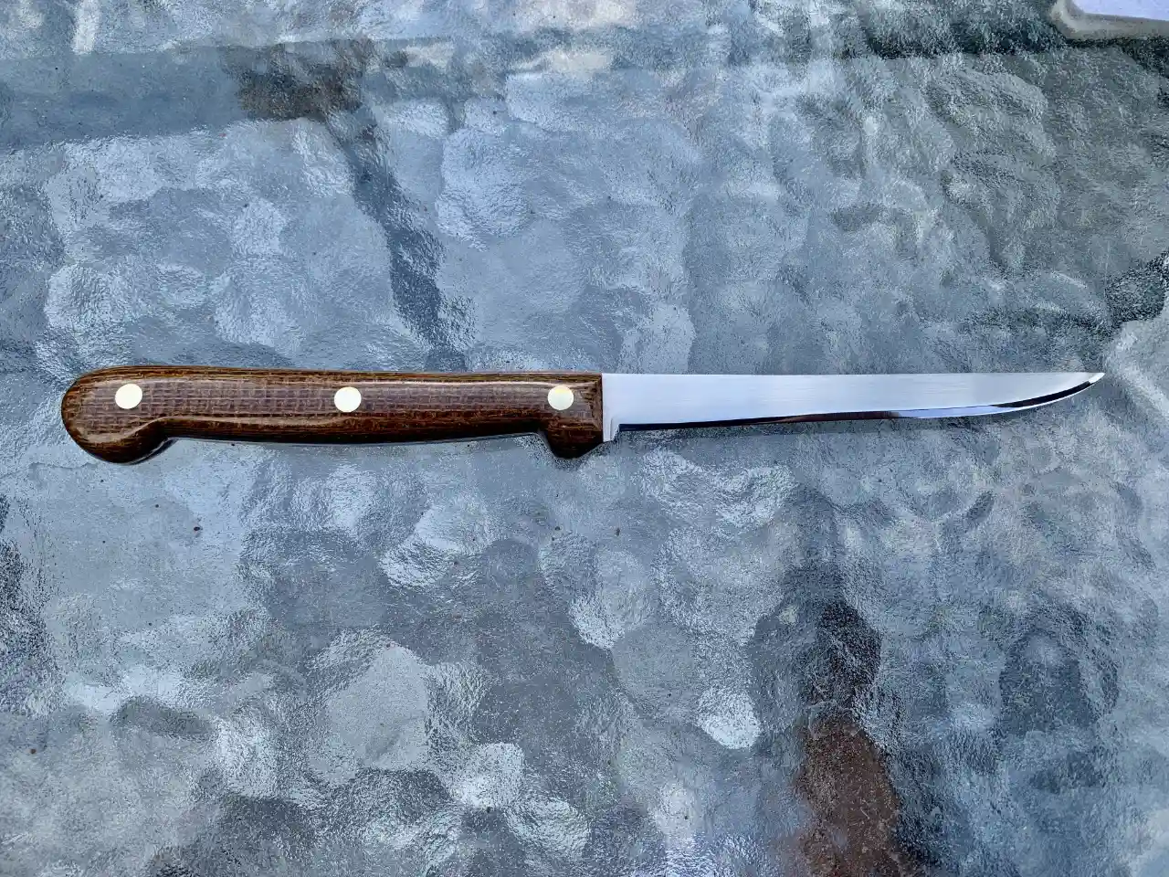Stainless steel boning knife with burlap micarta handles - rear view