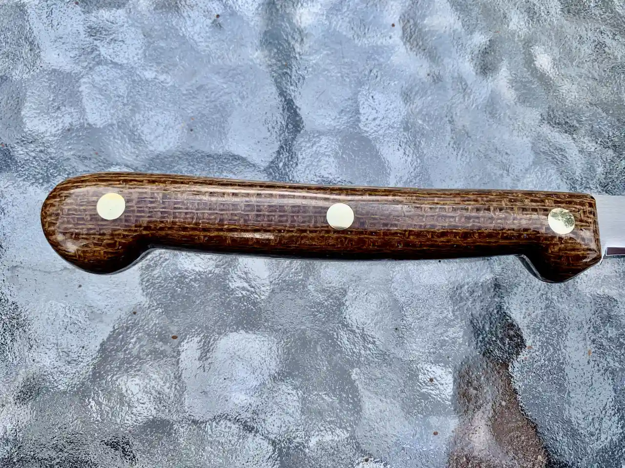 Stainless steel boning knife with burlap micarta handles - closeup of handle rear view