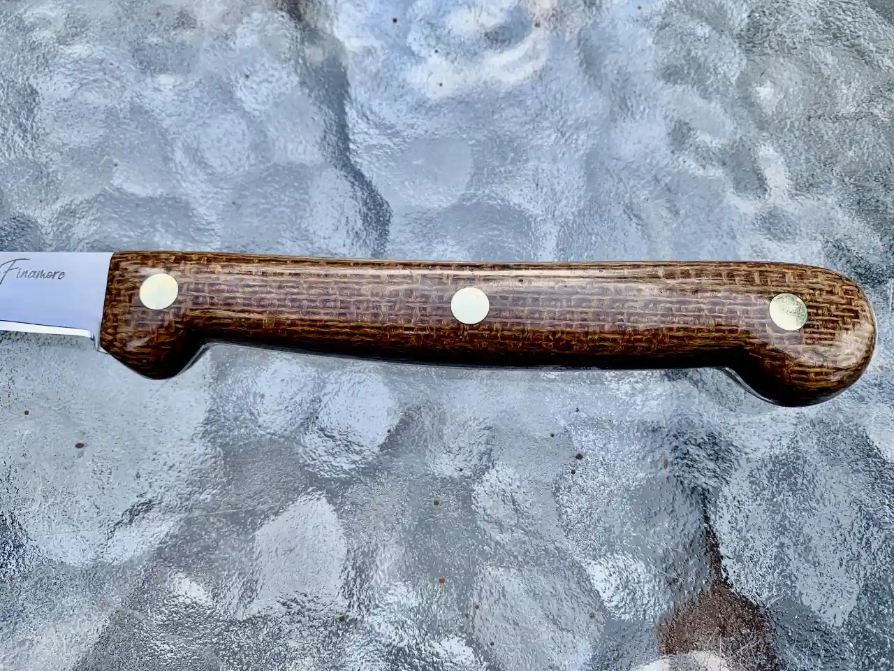 Stainless steel boning knife with burlap micarta handles - closeup of handle front view