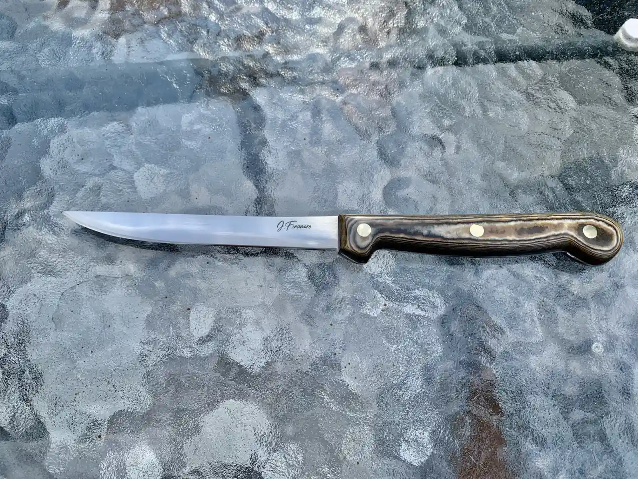 Stainless steel boning knife with tri-color Richlite handles - front view