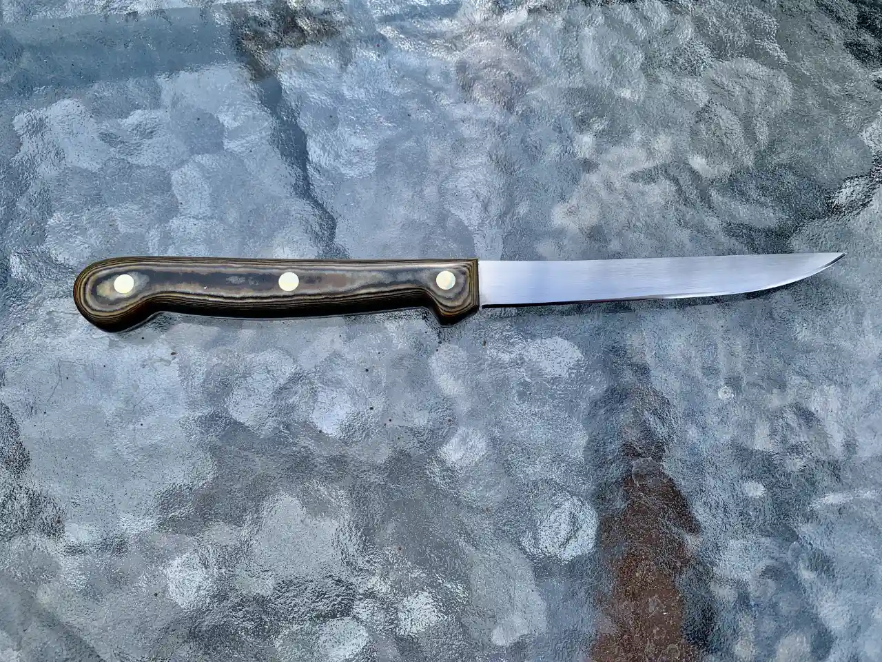 Stainless steel boning knife with tri-color Richlite handles - rear view