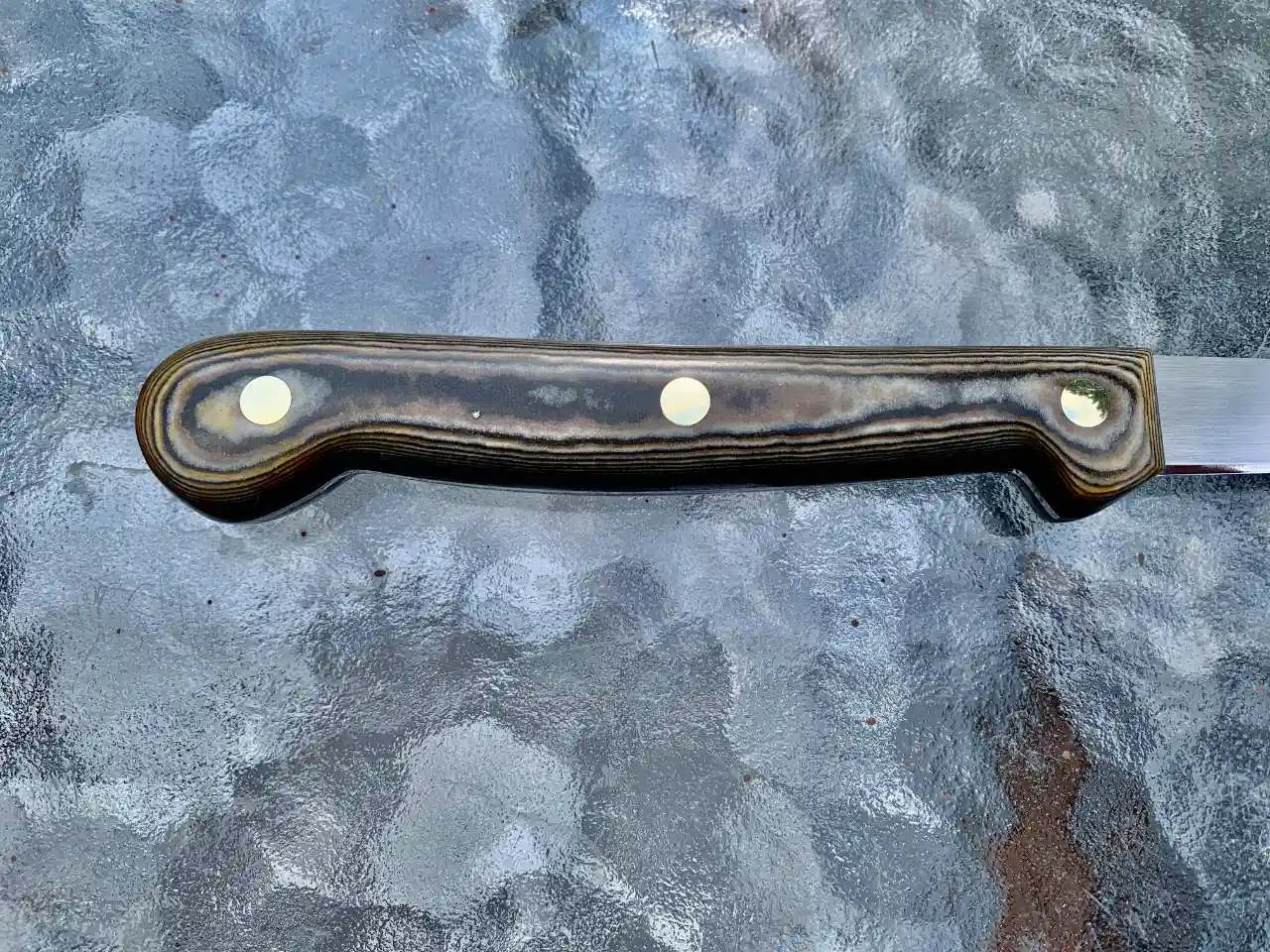 Stainless steel boning knife with tri-color Richlite handles - closeup of handle rear view