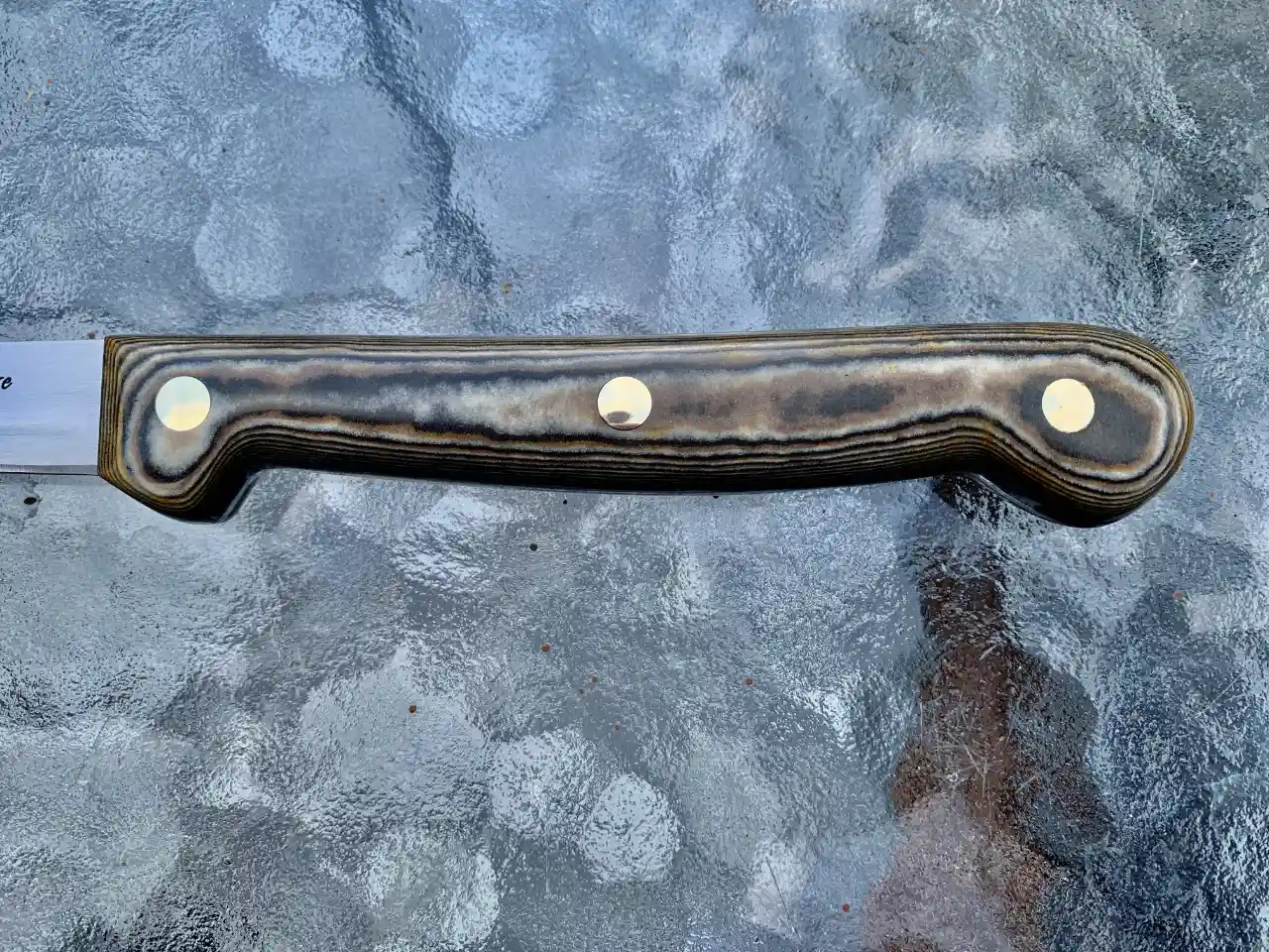 Stainless steel boning knife with tri-color Richlite handles - closeup of handle front view