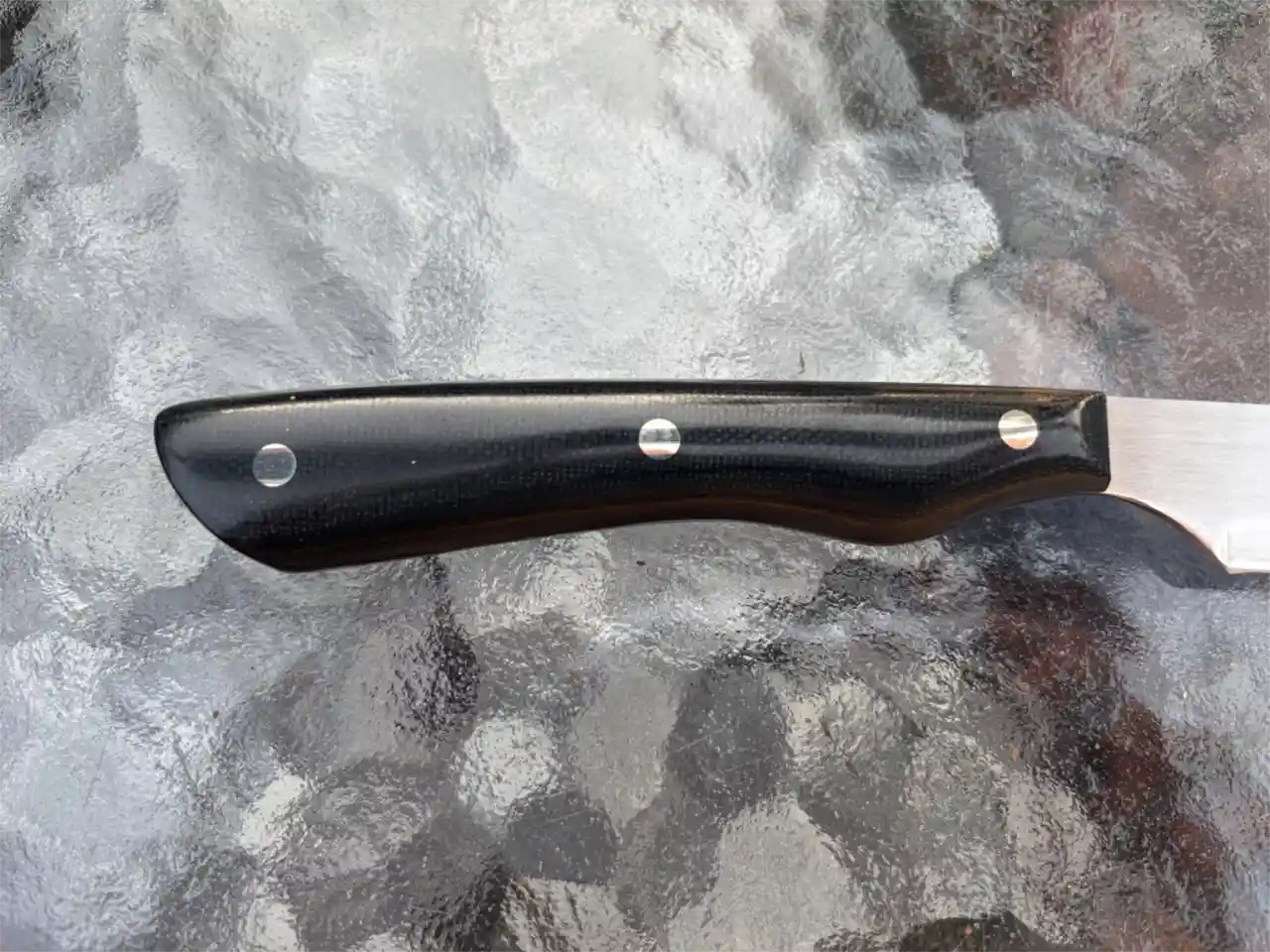 Bird and trout knife with black micarta handles - closeup of handle, rear view