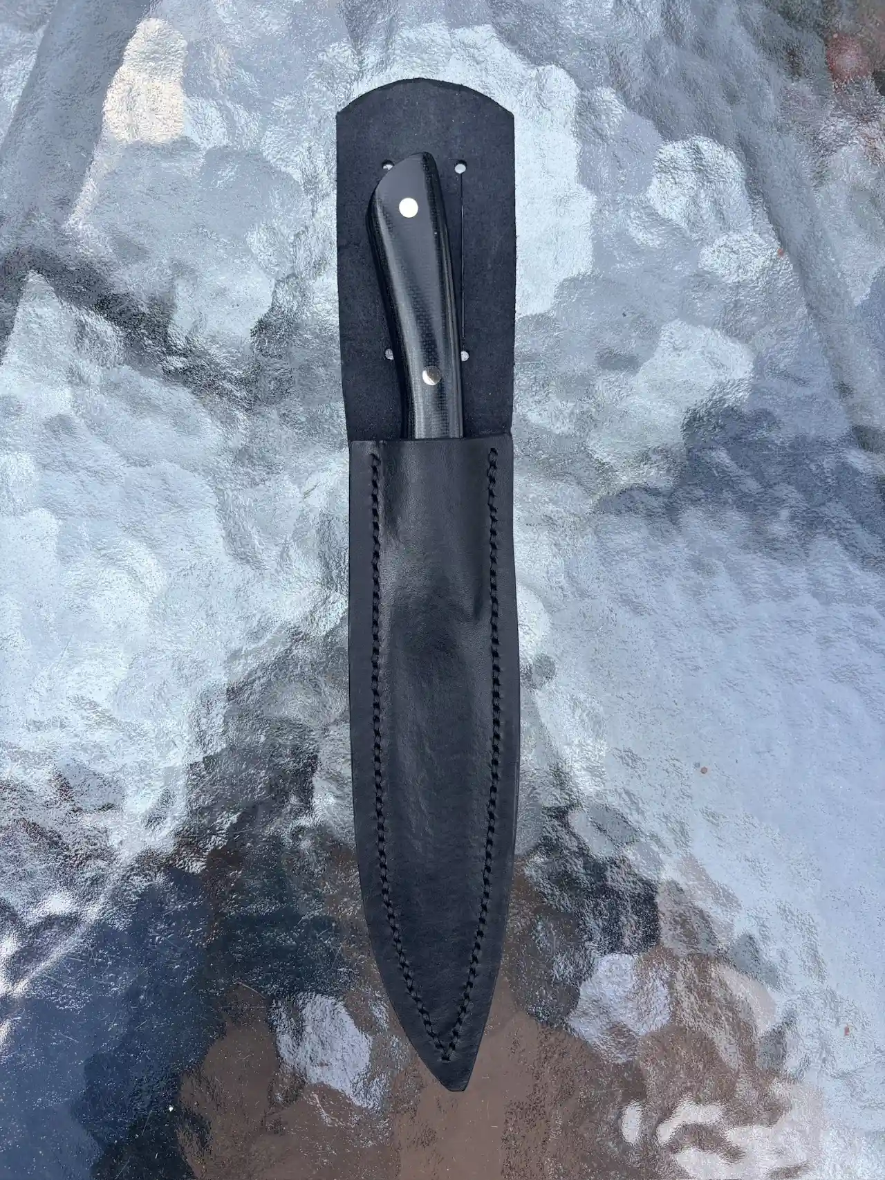 Bird and trout knife with black micarta handles in custom leather sheath