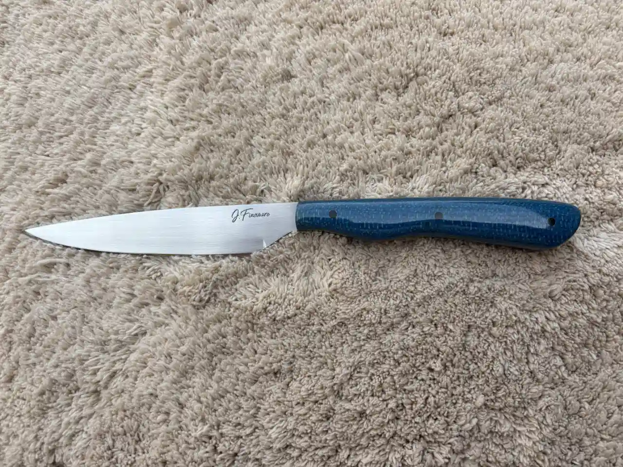 Bird and trout knife with admiral blue jute micarta handles - front view
