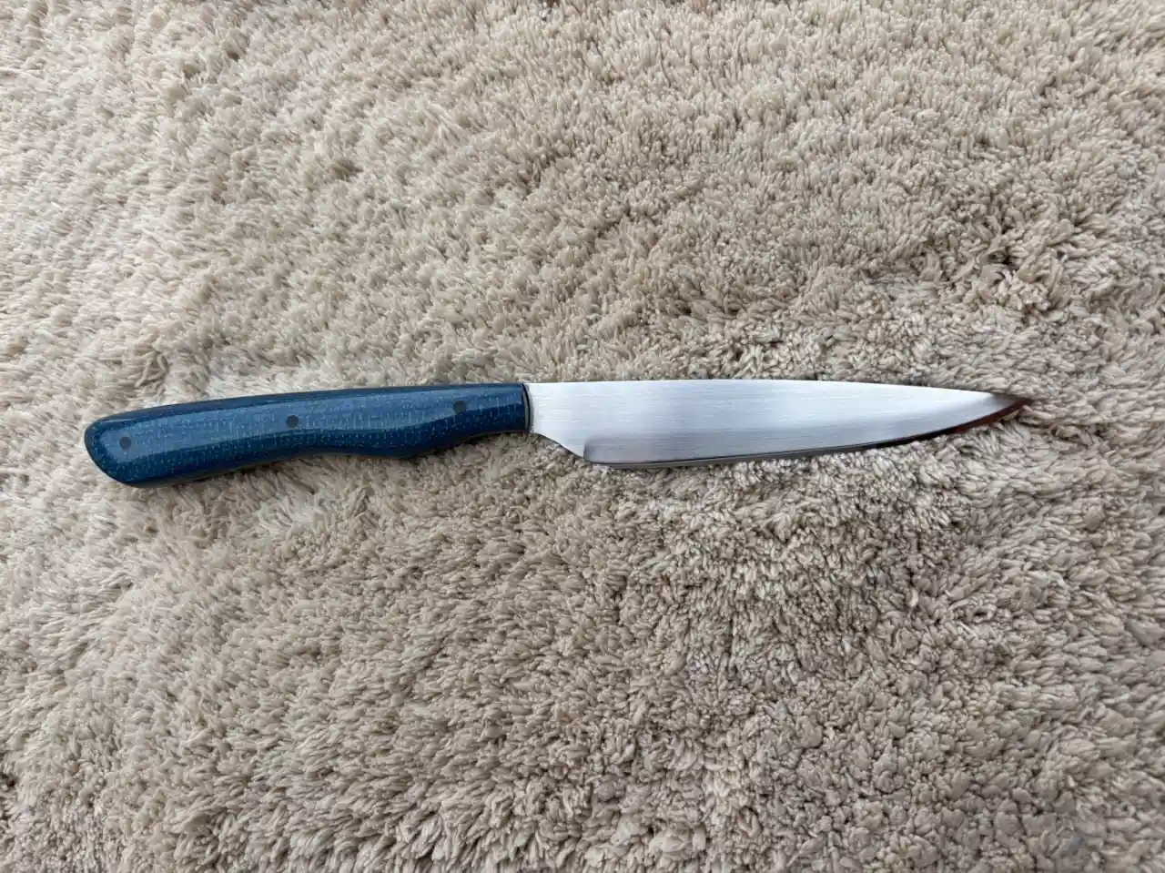Bird and trout knife with admiral blue jute micarta handles - rear view