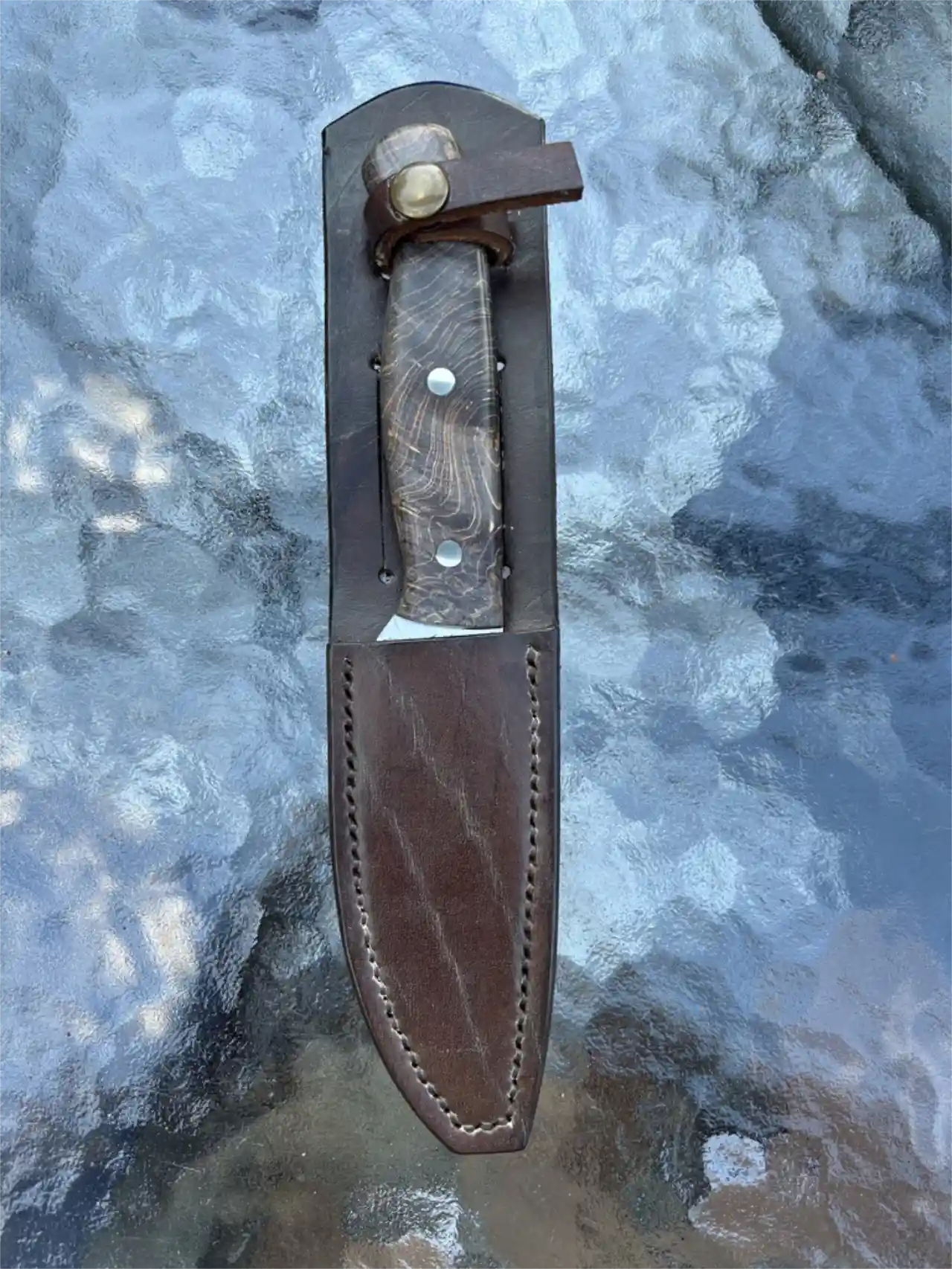 Bushcraft knife with dyed maple burl wood handles in a custom leather sheath