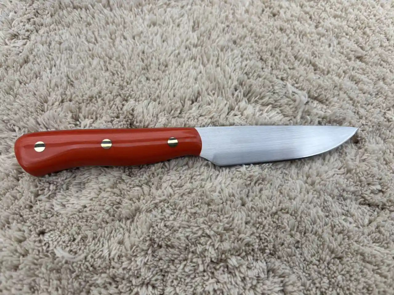 Kitchen paring knife with bengal orange micarta handles - front view