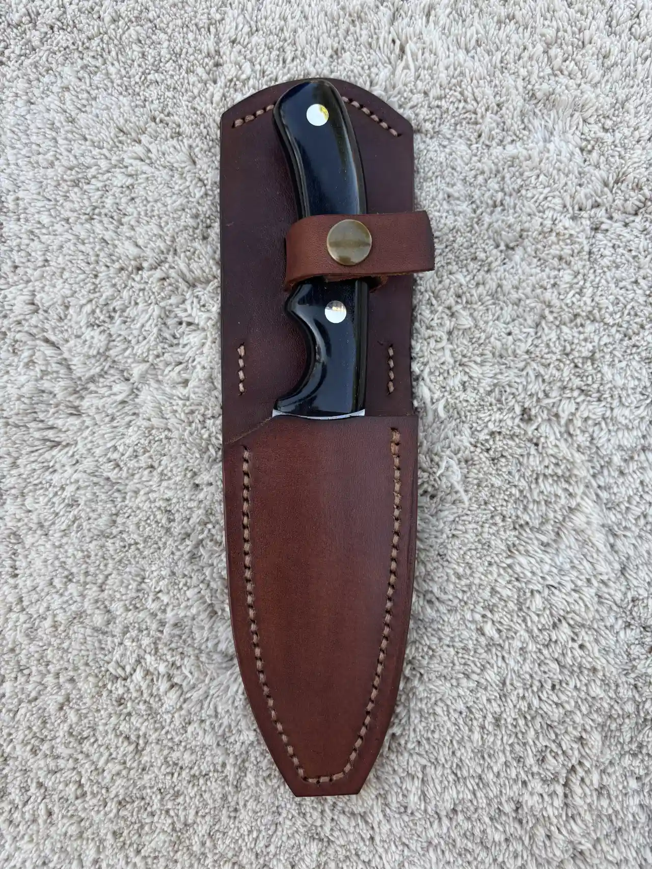Pro hunter with natural ebony wood handles in a custom leather sheath