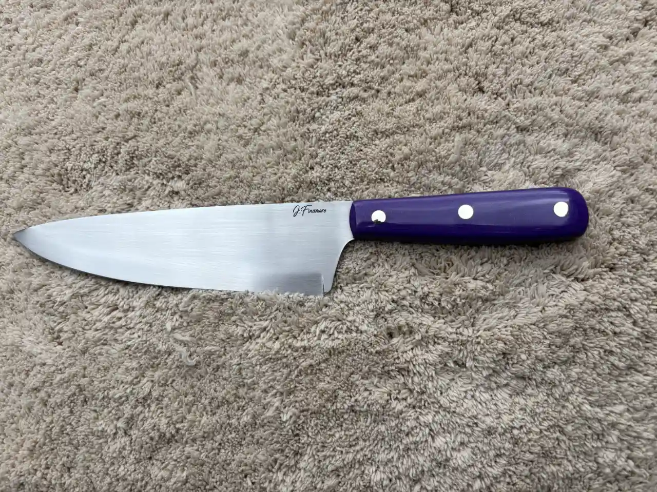 Chefs knife with plum colored micarta handles - front view