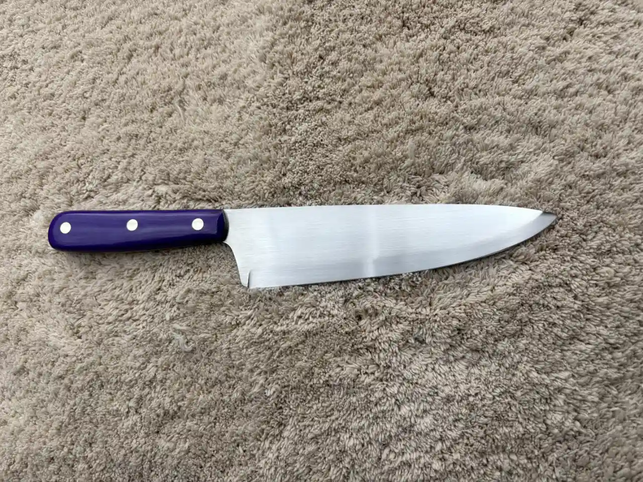 Chefs knife with plum colored micarta handles - rear view