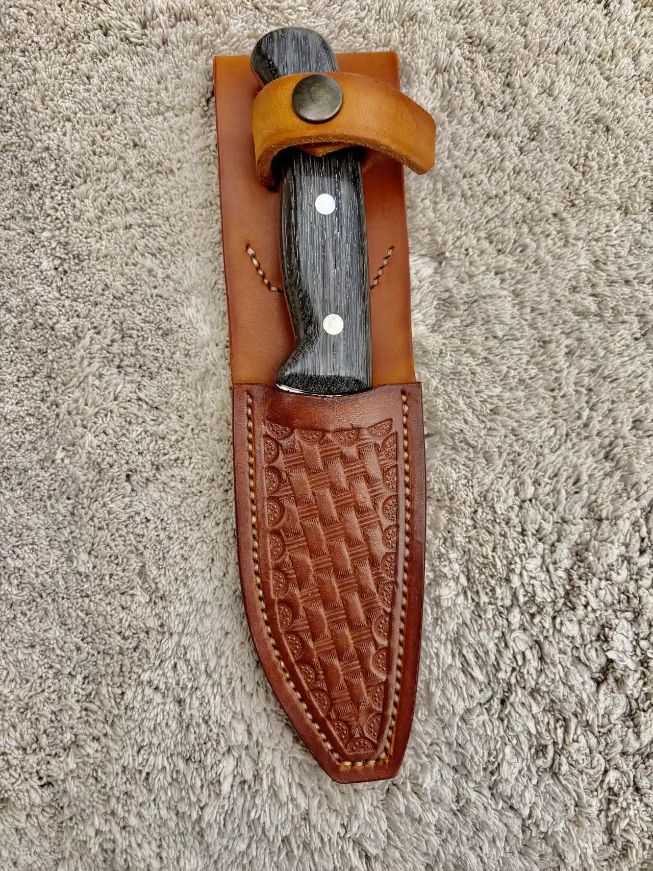 Bushcraft knife with bog oak handles in a custom hand tooled, leather sheath