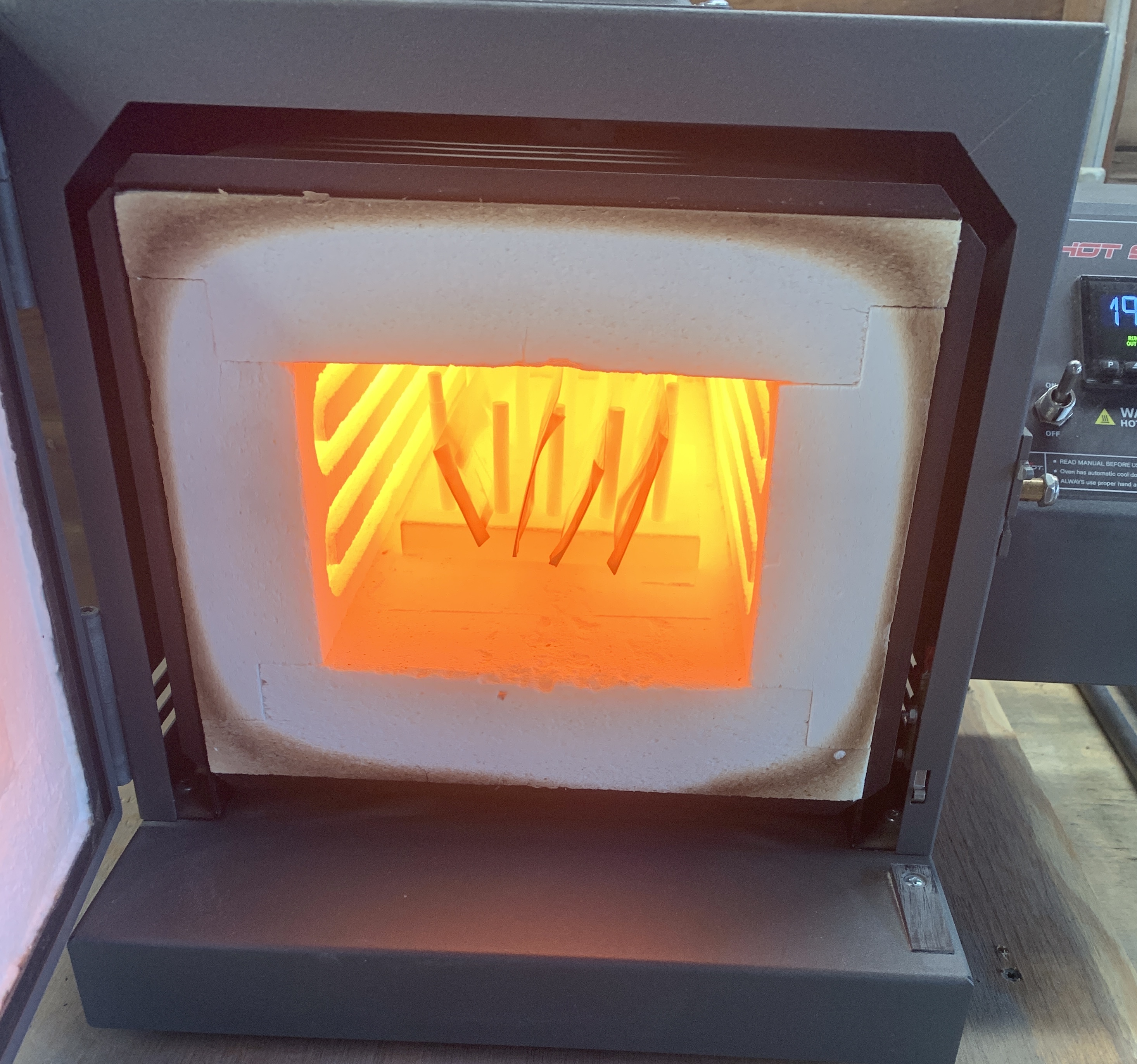 Knife kiln with knives inside glowing bright orange